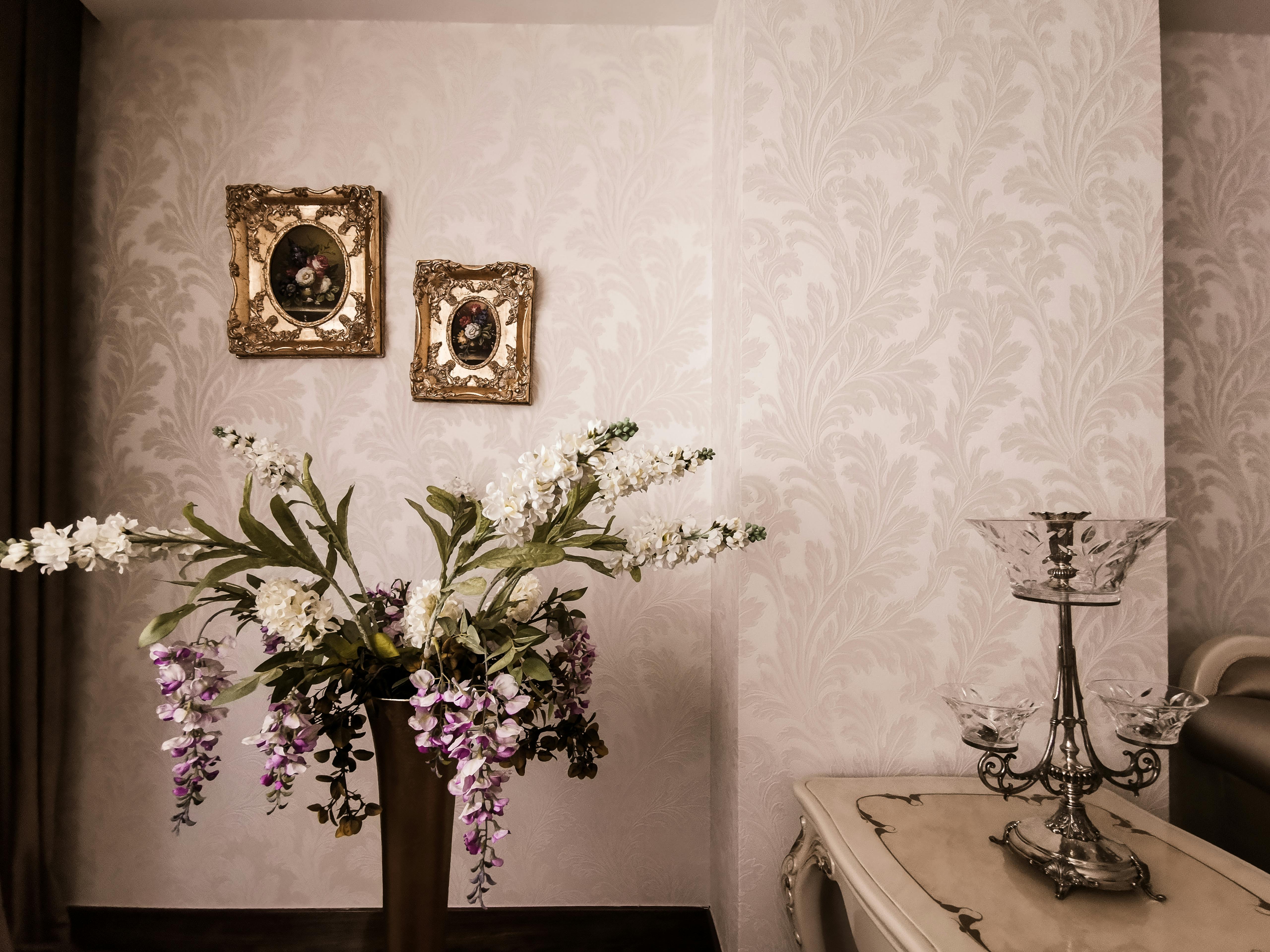 Service A sophisticated interior with a floral arrangement, ornate frames, and vintage decor.