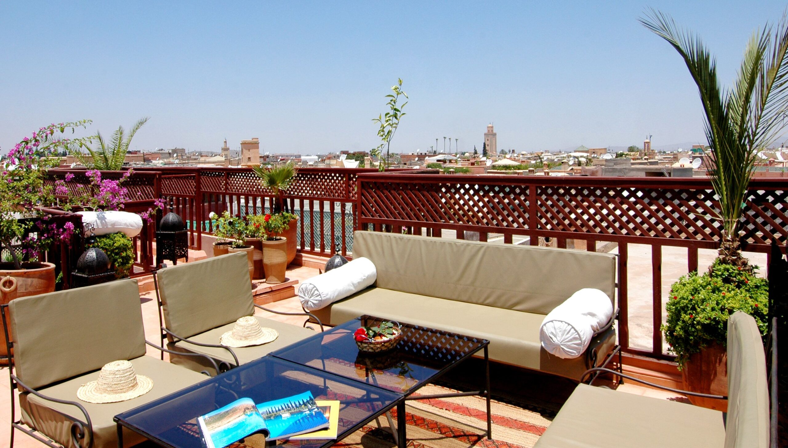 Elegant rooftop terrace with city view, featuring outdoor seating, plants, and a relaxing atmosphere.